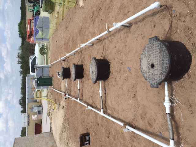 Underground propane tank installation in progress — pipes and access covers being installed by Absolute Propane technicians in Central Texas