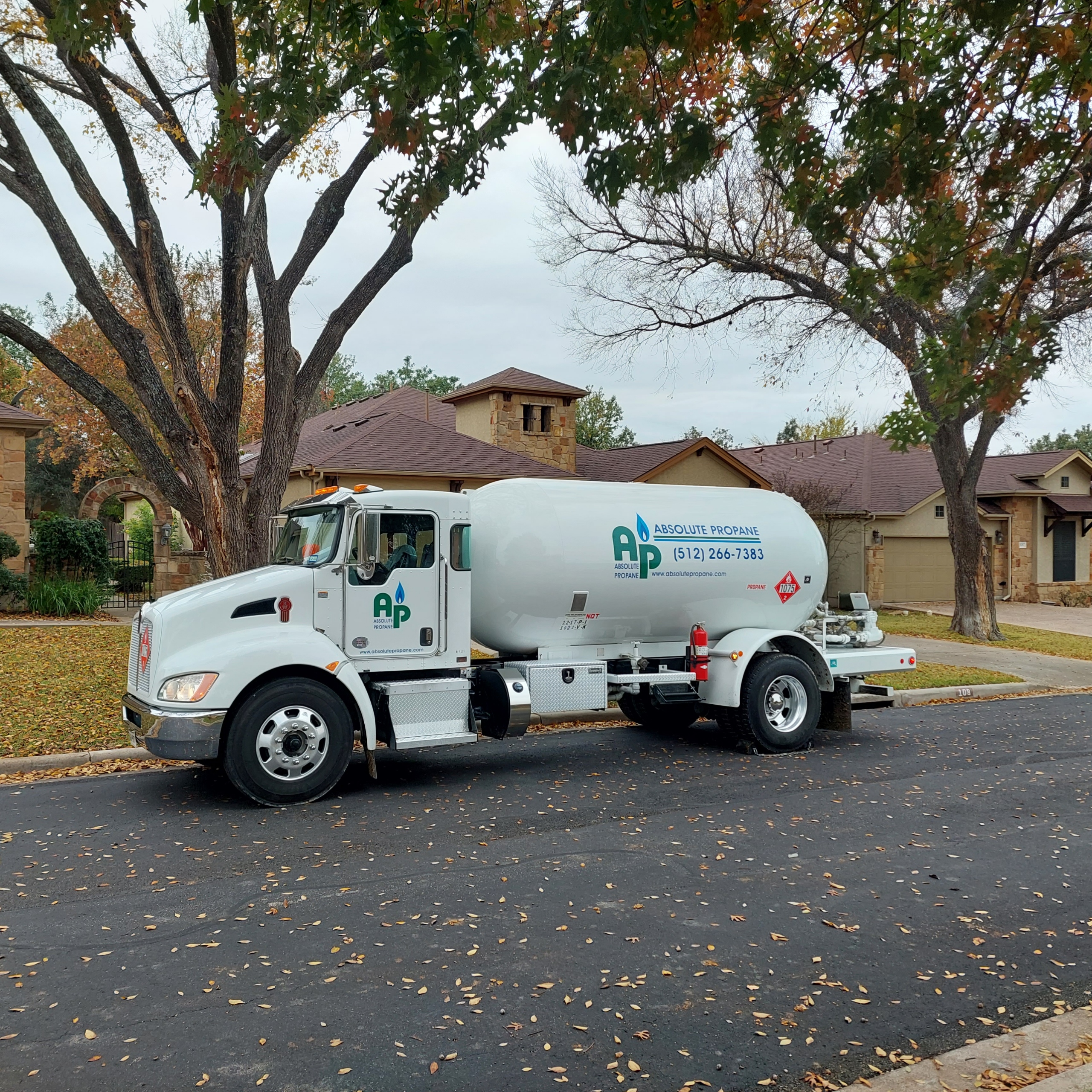 Absolute Propane branded delivery truck making a residential propane delivery in Austin, TX
