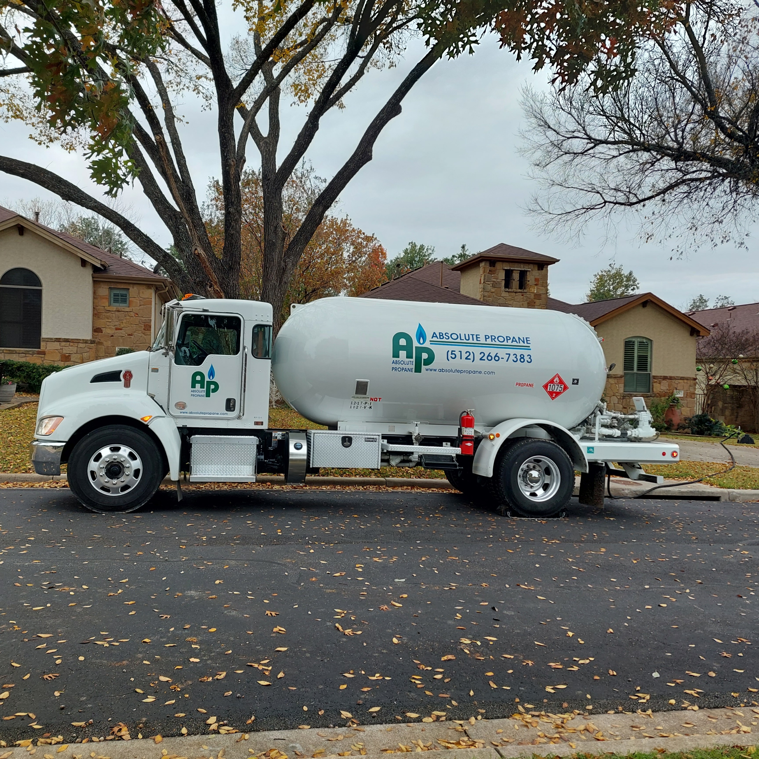 Absolute Propane delivery truck in a residential neighborhood — reliable local propane service in Austin, TX